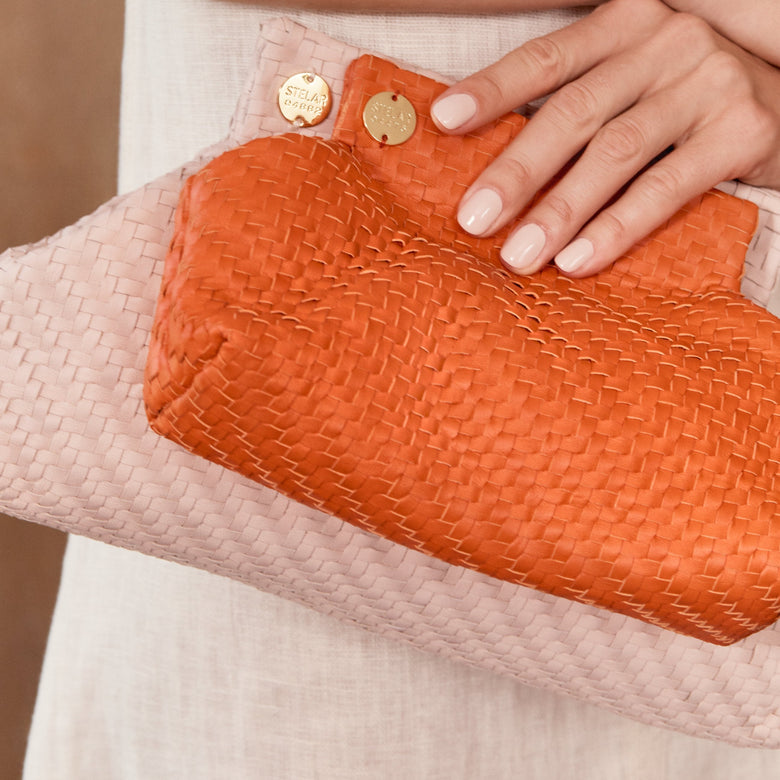 Small orange hotsell clutch bag
